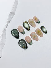 Bali Escape almond press-on nails with emerald cat-eye shimmer, 3D frosted flowers and gold accents – Éclaire Studio