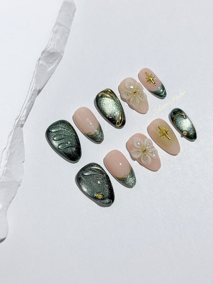 Bali Escape almond press-on nails with emerald cat-eye shimmer, 3D frosted flowers and gold accents – Éclaire Studio