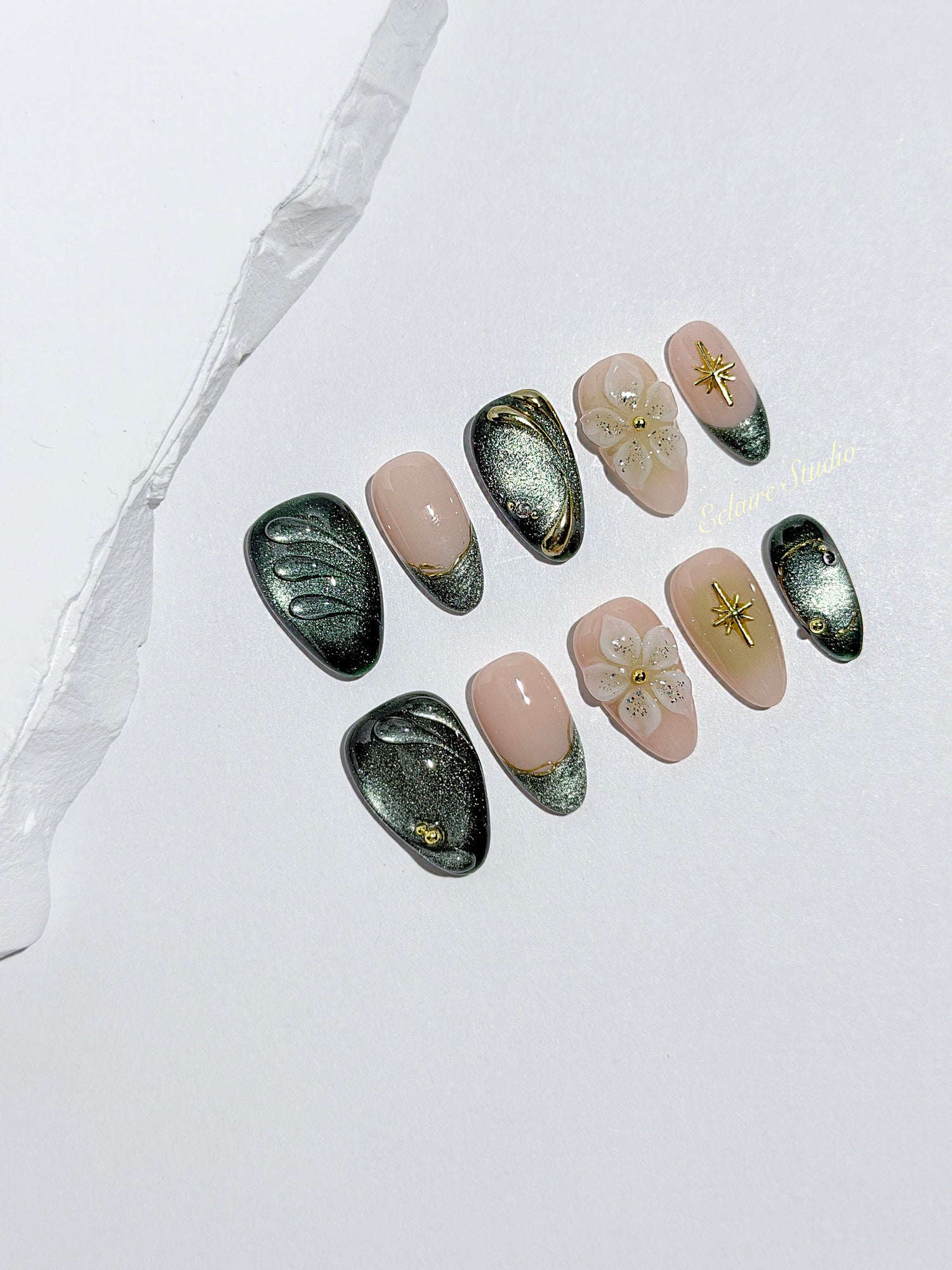 Bali Escape almond press-on nails with emerald cat-eye shimmer, 3D frosted flowers and gold accents – Éclaire Studio