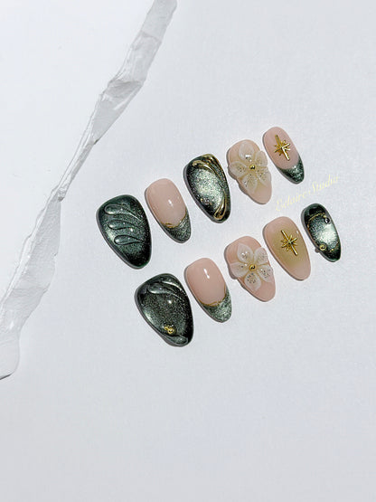 Bali Escape almond press-on nails with emerald cat-eye shimmer, 3D frosted flowers and gold accents – Éclaire Studio