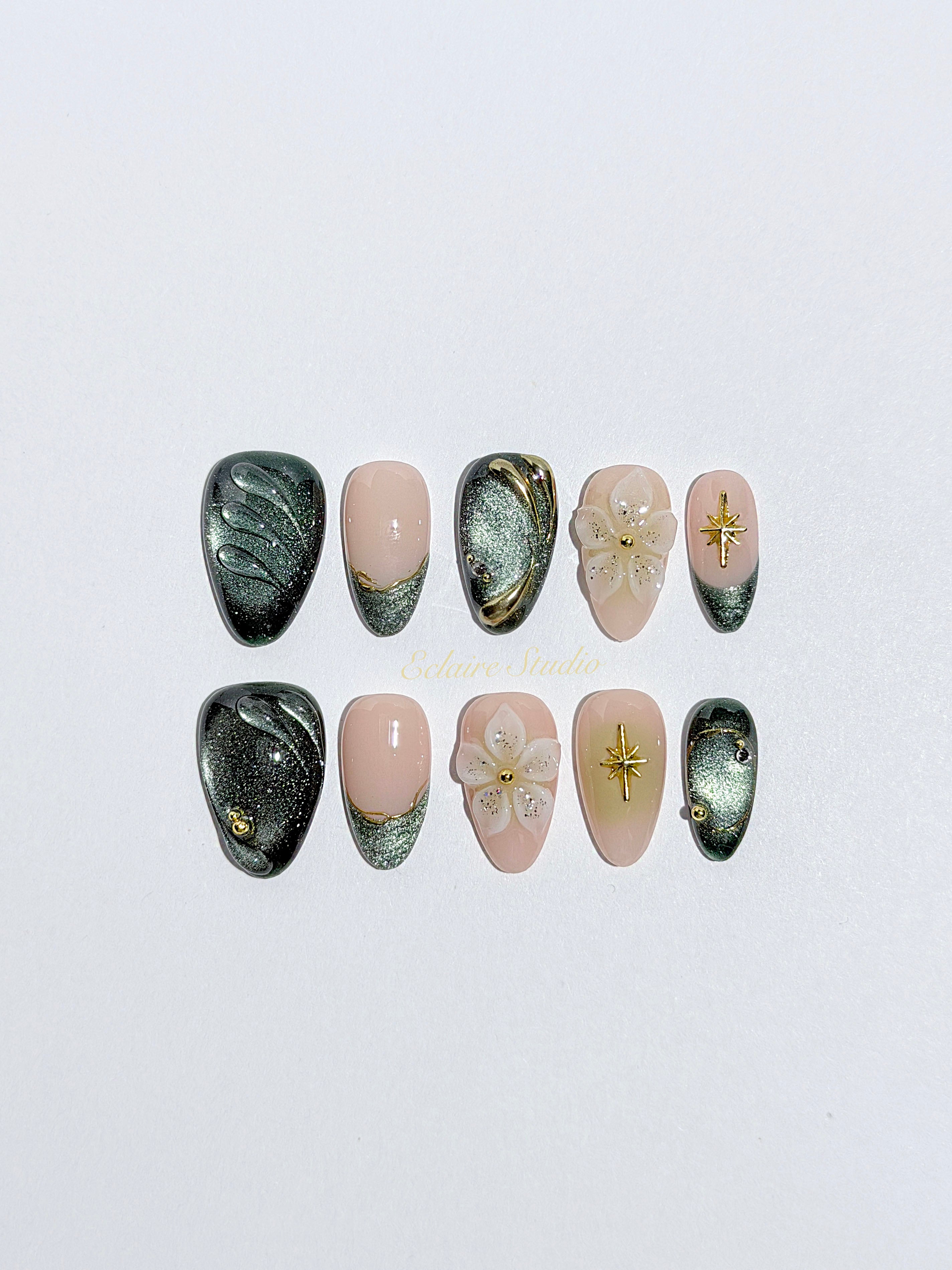 Bali Escape almond press-on nails with emerald cat-eye shimmer, 3D frosted flowers and gold accents – Éclaire Studio