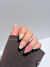 Eclaire Studio 3D Summer short almond press-on nails with sheer nude bases, sparkling silver cat-eye magnetic French tips, hand-painted colorful starfish, and pink 3D sculpted seashells.