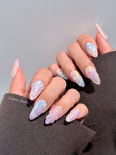 Handcrafted luxury press-on nails in a medium almond shape featuring an iridescent multi-toned glazed finish with 3D sculpted shell ridges and delicate mini pearls.