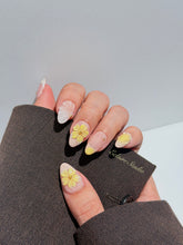 Eclaire Studio Yellow Summer short almond press-on nails featuring a sheer nude base with yellow French tips, hand-sculpted 3D flowers, frosted 3D seashells