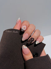 Eclaire Nail Studio 3D Floral Polka dot pink base with alternating black and white polka dot French tips, and hand-sculpted 3D frosted white flowers with gold bead centers, Short Almond