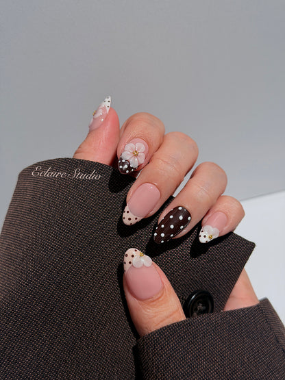 Eclaire Nail Studio 3D Floral Polka dot pink base with alternating black and white polka dot French tips, and hand-sculpted 3D frosted white flowers with gold bead centers, Short Almond