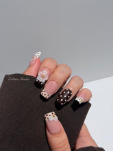 Eclaire Nail Studio 3D Floral Polka dot pink base with alternating black and white polka dot French tips, and hand-sculpted 3D frosted white flowers with gold bead centers, Medium Square
