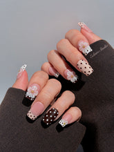 Eclaire Nail Studio 3D Floral Polka dot pink base with alternating black and white polka dot French tips, and hand-sculpted 3D frosted white flowers with gold bead centers, Medium Square