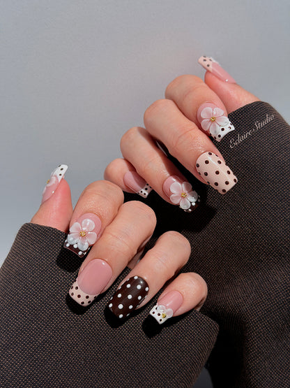 Eclaire Nail Studio 3D Floral Polka dot pink base with alternating black and white polka dot French tips, and hand-sculpted 3D frosted white flowers with gold bead centers, Medium Square