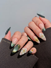 Bali Escape almond press-on nails with emerald cat-eye shimmer, 3D frosted flowers and gold accents – Éclaire Studio
