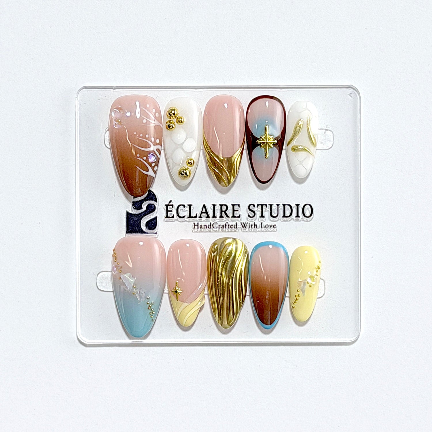 Horizon mixed-tone press-on nails in brown, butter yellow, sky blue and cream with gold chrome wave – Éclaire Studio