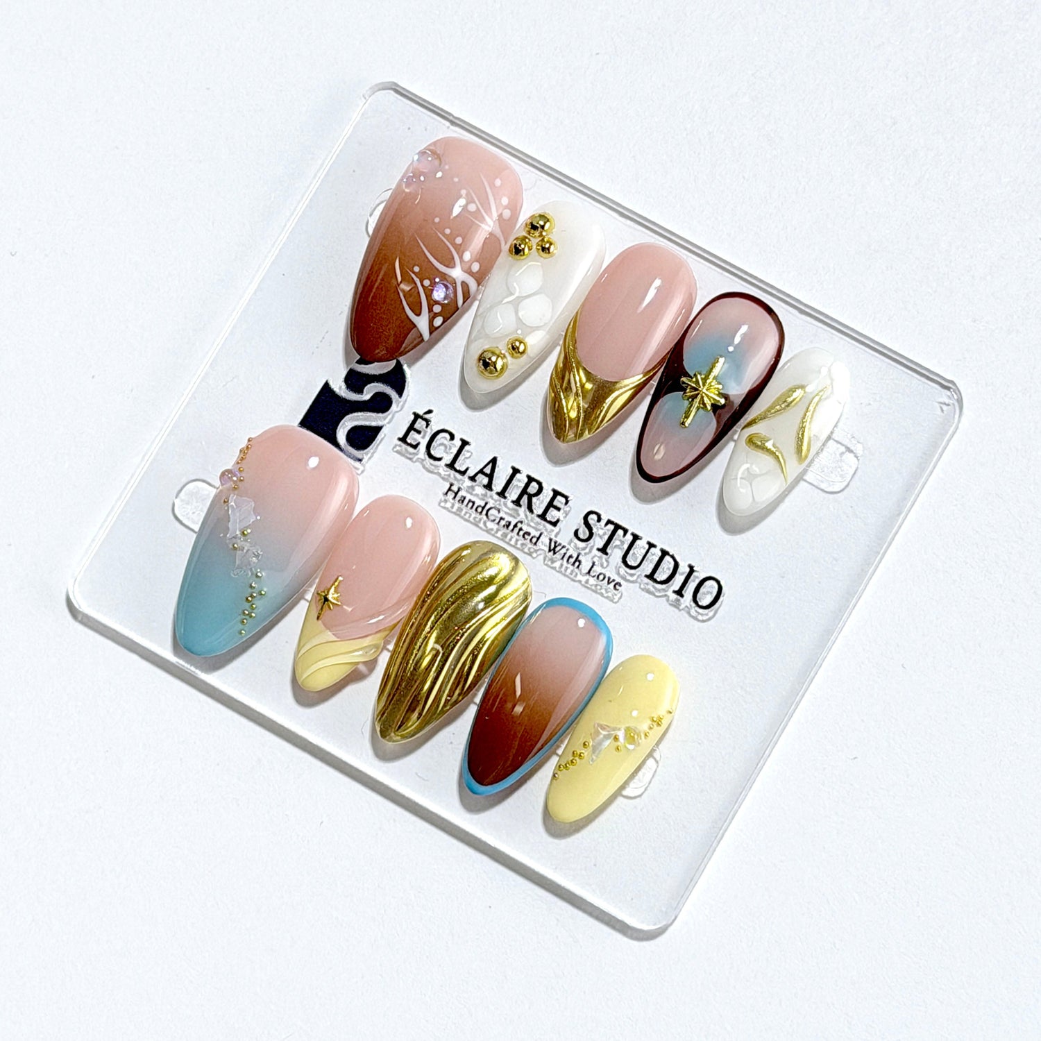 Horizon mixed-tone press-on nails in brown, butter yellow, sky blue and cream with gold chrome wave – Éclaire Studio