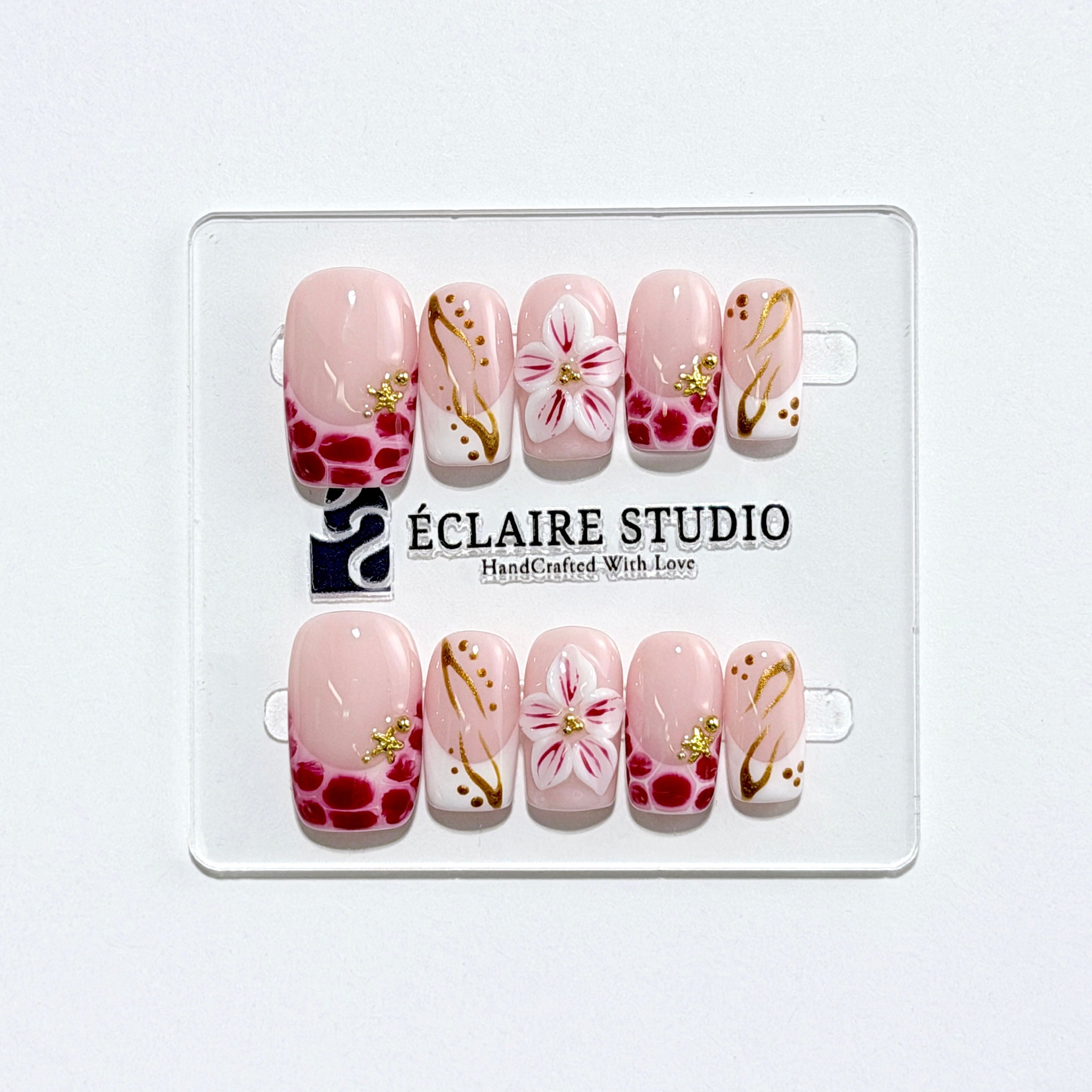 Marbella square press-on nails with wine watercolor French tips, gold swirls, starfish charms and 3D lily – Éclaire Studio