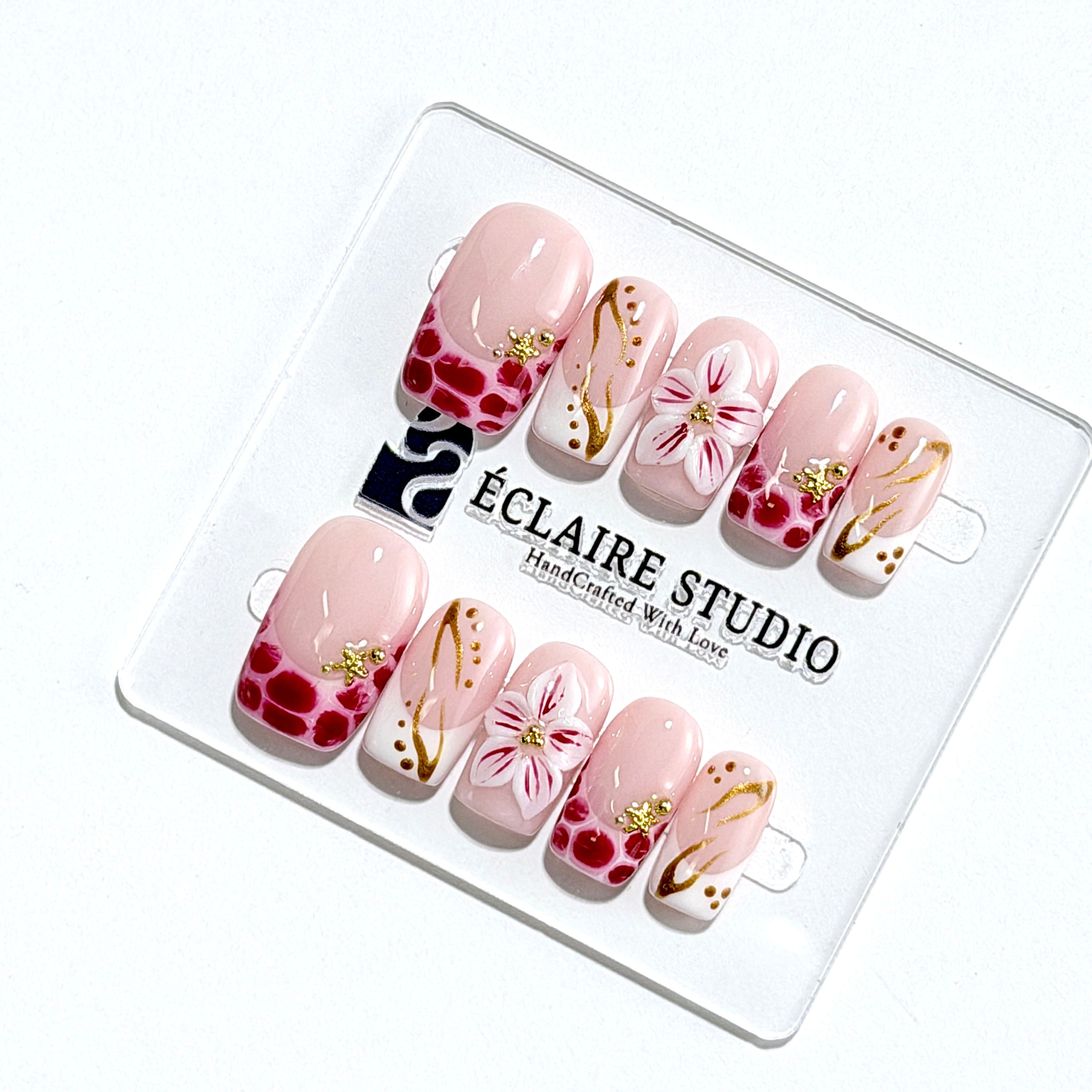 Marbella square press-on nails with wine watercolor French tips, gold swirls, starfish charms and 3D lily – Éclaire Studio