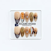 Dune caramel and espresso press-on nails with gold chrome wave, starbursts and opal gem – Éclaire Studio