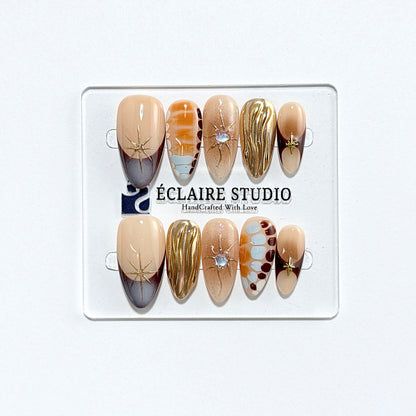 Dune caramel and espresso press-on nails with gold chrome wave, starbursts and opal gem – Éclaire Studio