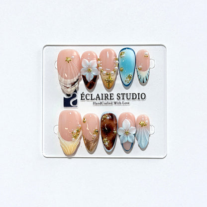 Seabreeze blue-to-amber ombré press-on nails with 3D flowers, pearls and shell French tips – Éclaire Studio