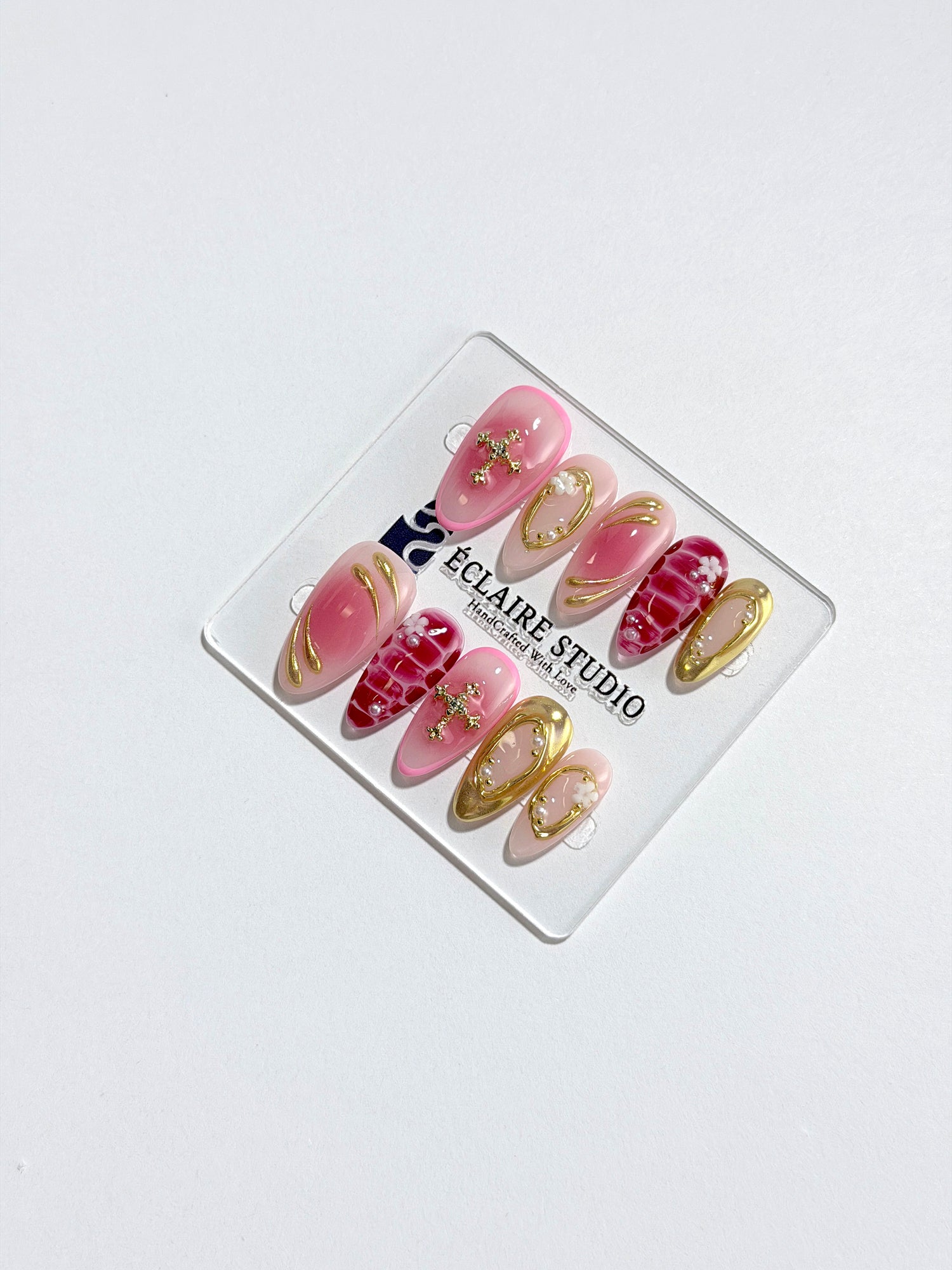 Strawberry Latte red ombré press-on nails with molten gold frames and floral accents – Éclaire Studio