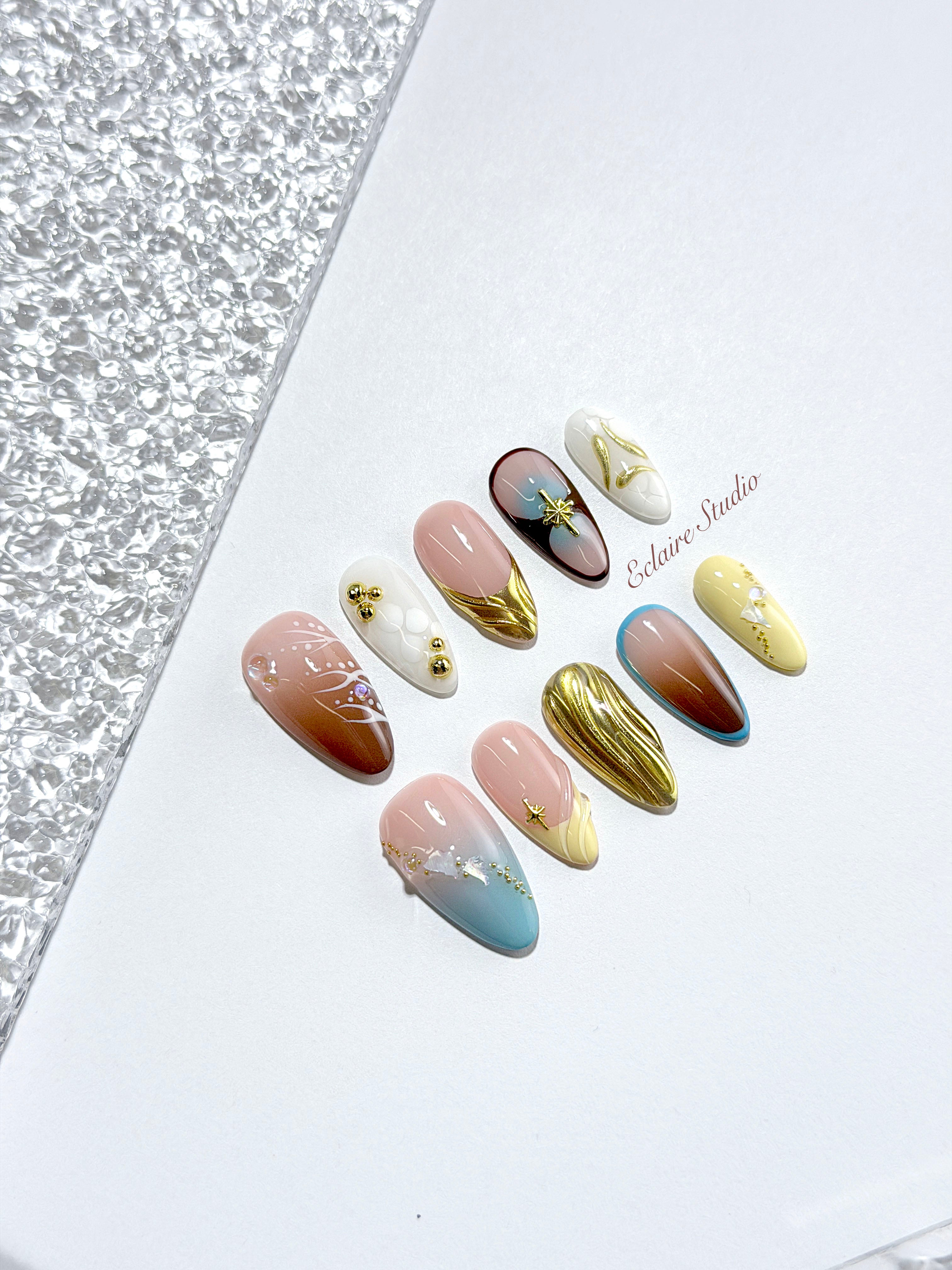 Horizon mixed-tone press-on nails in brown, butter yellow, sky blue and cream with gold chrome wave – Éclaire Studio