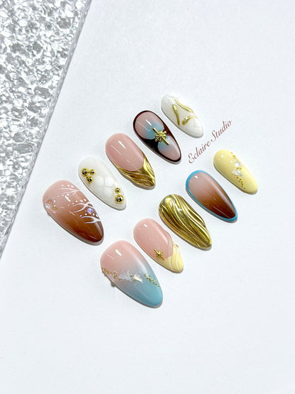 Horizon mixed-tone press-on nails in brown, butter yellow, sky blue and cream with gold chrome wave – Éclaire Studio