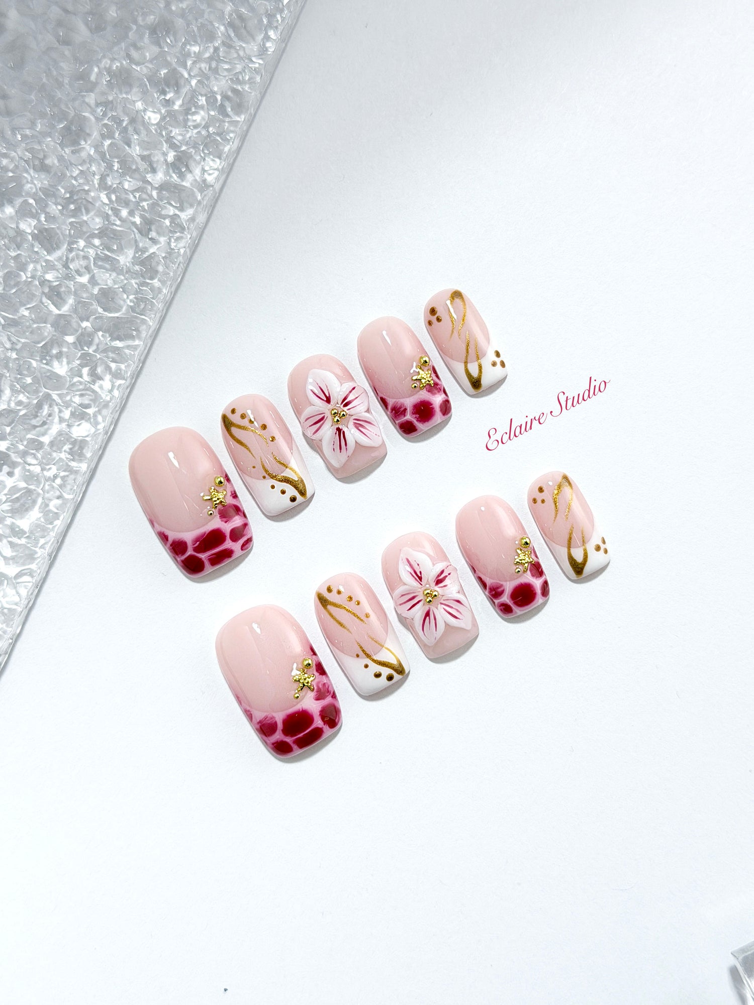 Marbella square press-on nails with wine watercolor French tips, gold swirls, starfish charms and 3D lily – Éclaire Studio