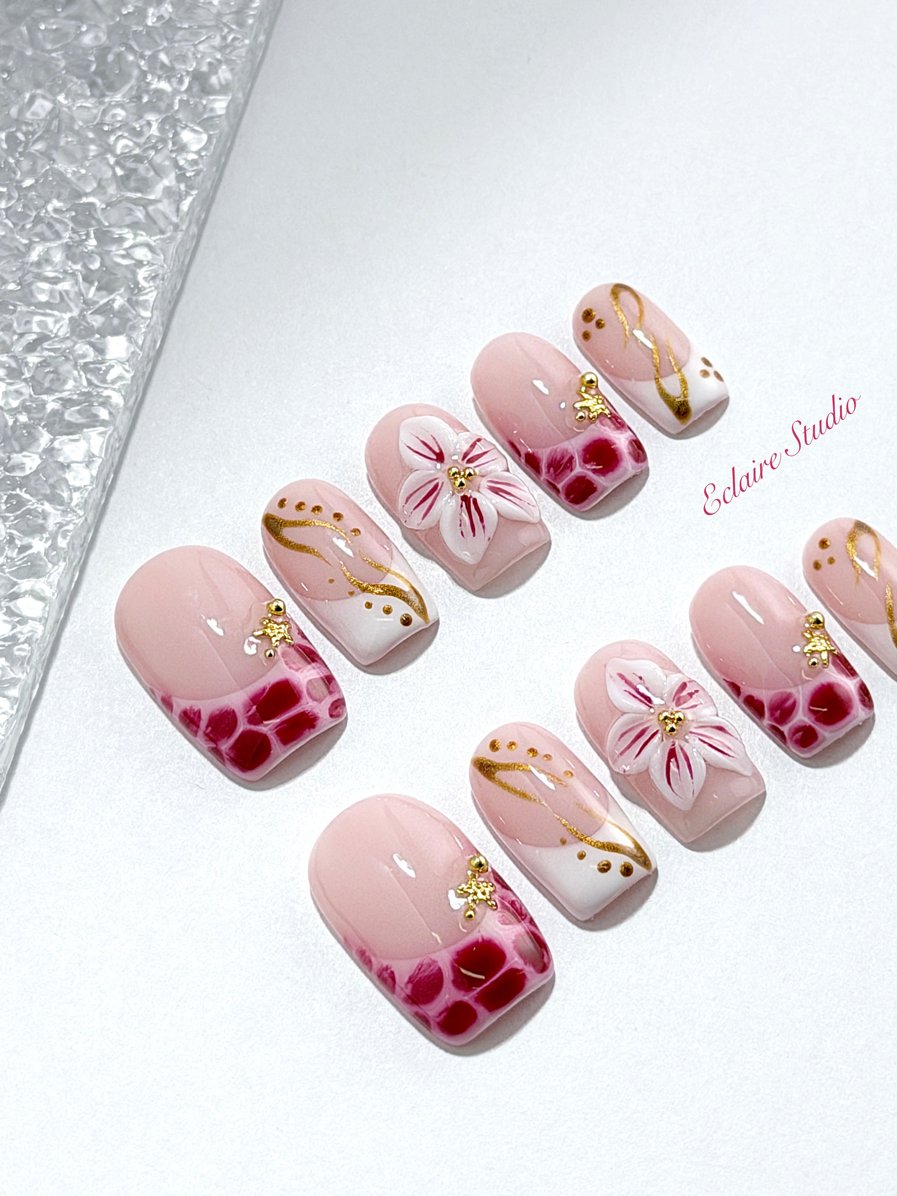 Marbella square press-on nails with wine watercolor French tips, gold swirls, starfish charms and 3D lily – Éclaire Studio