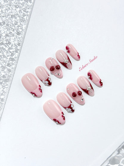 Cherry Kiss pink French press-on nails with wine florals, glossy 3D cherries and silver charms – Éclaire Studio