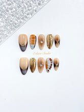 Dune caramel and espresso press-on nails with gold chrome wave, starbursts and opal gem – Éclaire Studio