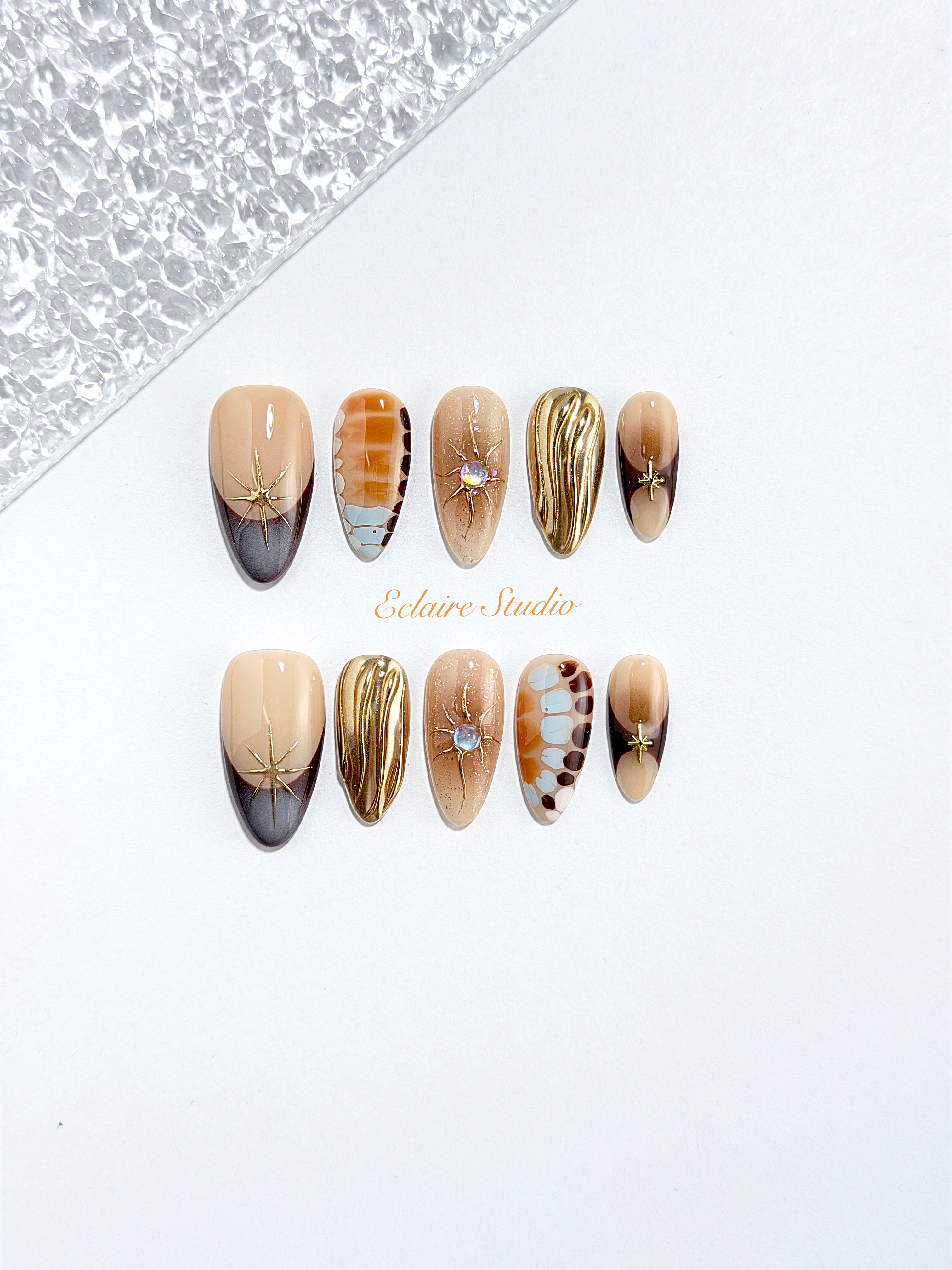 Dune caramel and espresso press-on nails with gold chrome wave, starbursts and opal gem – Éclaire Studio