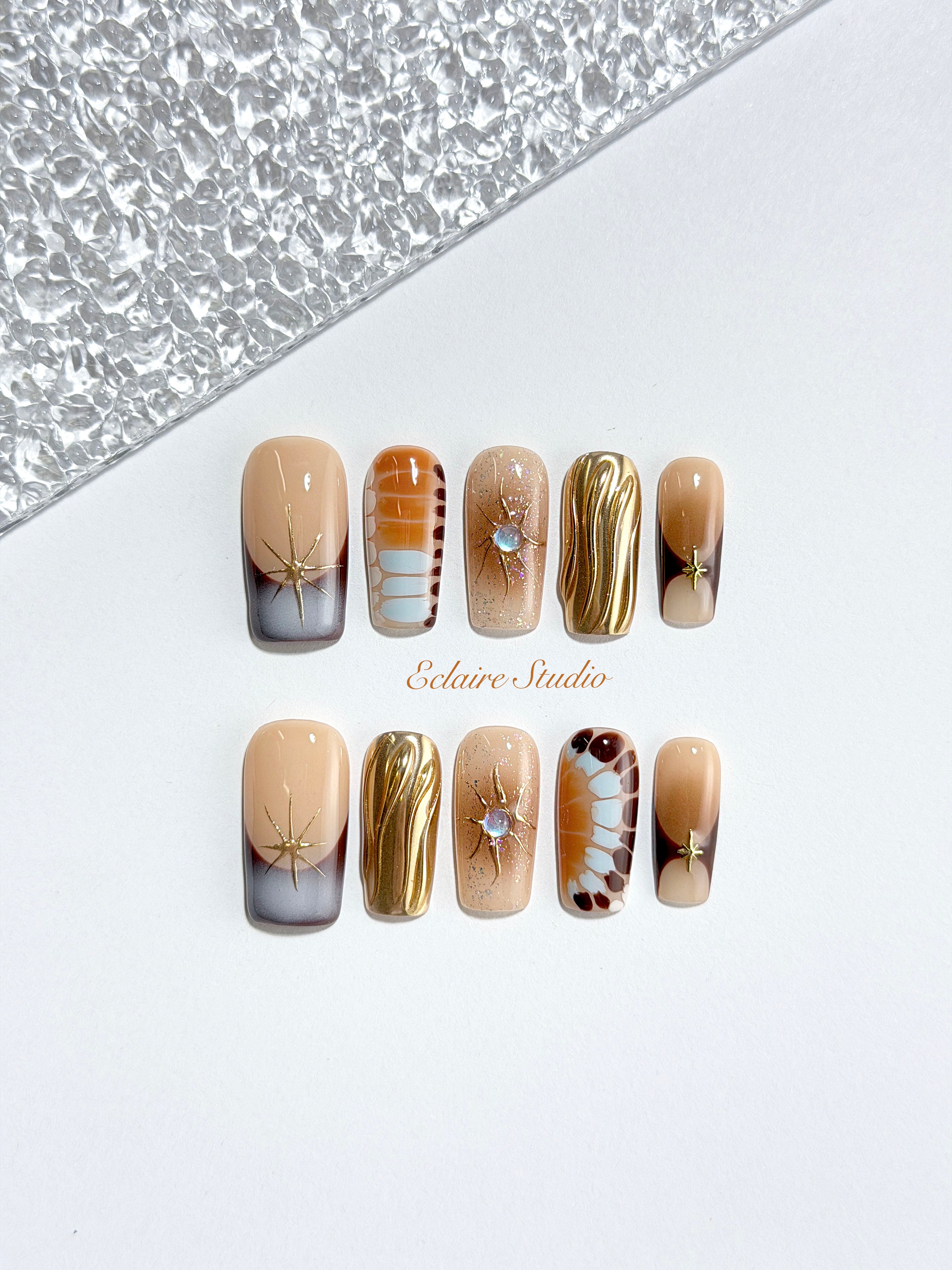 Dune caramel and espresso press-on nails with gold chrome wave, starbursts and opal gem – Éclaire Studio