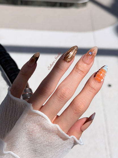 Dune caramel and espresso press-on nails with gold chrome wave, starbursts and opal gem – Éclaire Studio