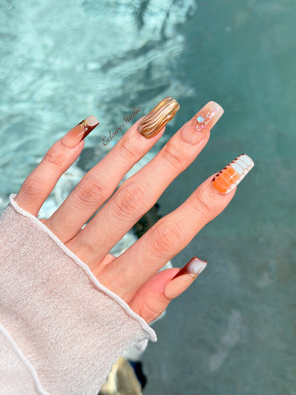 Dune caramel and espresso press-on nails with gold chrome wave, starbursts and opal gem – Éclaire Studio
