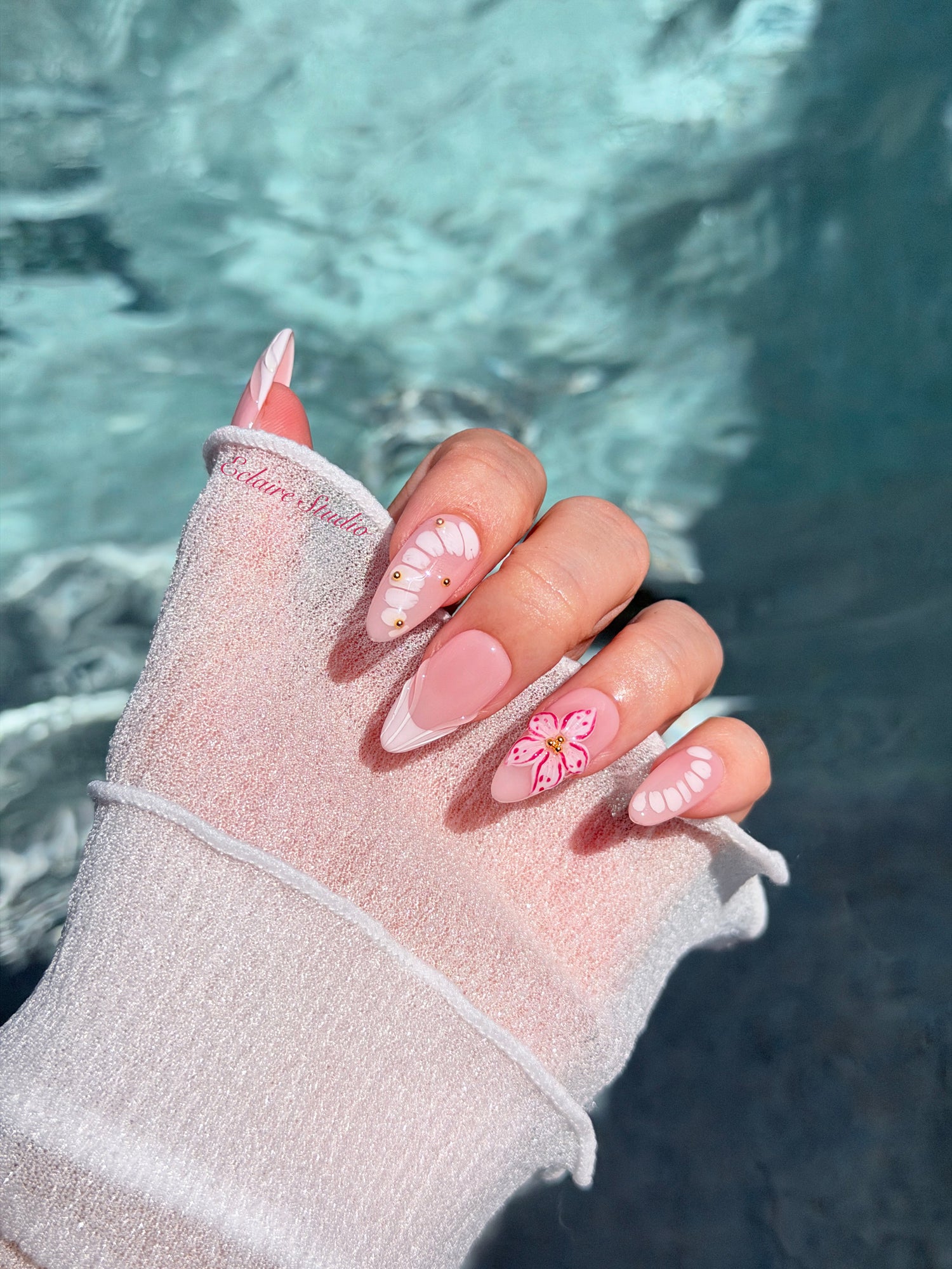 Belle Rose almond press-on nails with milky pink French tips, hand-painted petals and 3D floral accent – Éclaire Studio