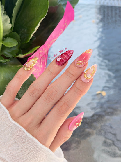 Strawberry Latte red ombré press-on nails with molten gold frames and floral accents – Éclaire Studio
